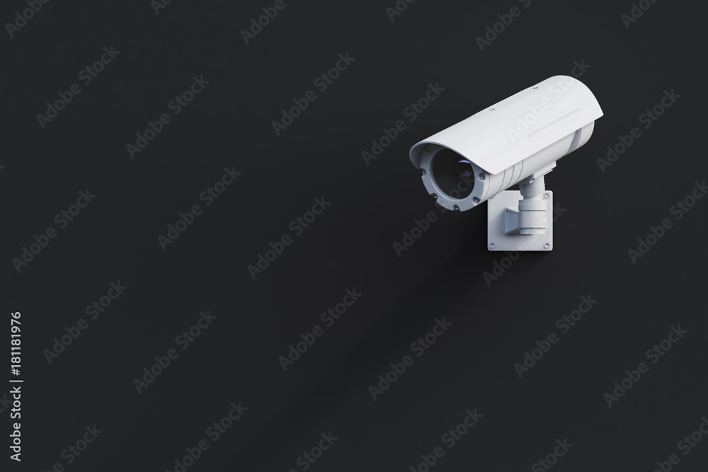 White CCTV camera on a black wall