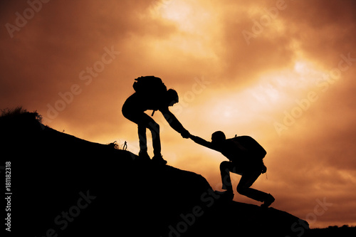 people help each other on top of mountain photo