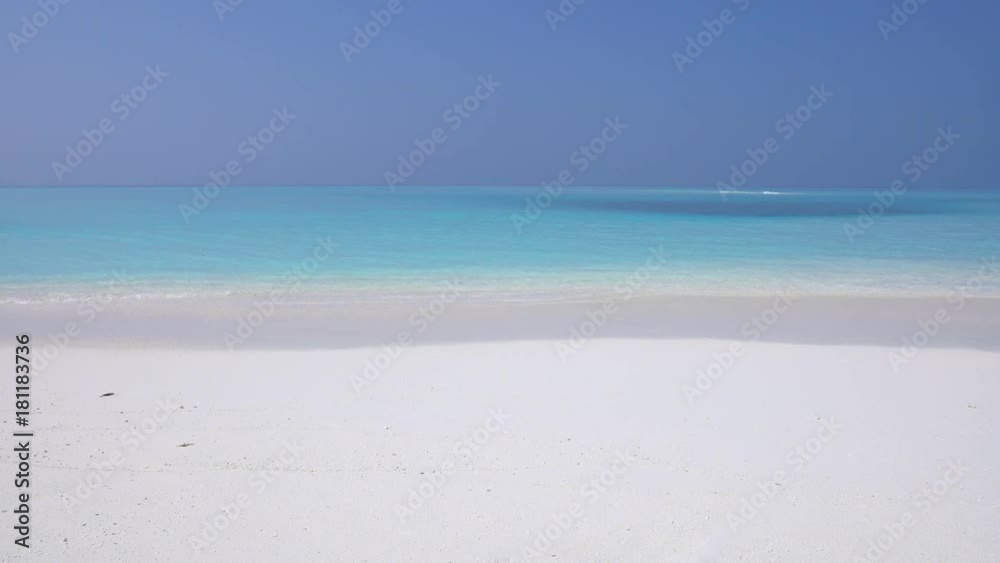Tropical sandy beach with calm waves on sandbank. Maldivian destination with nobody Tropical sandy beach with calm waves on sandbank. Maldivian destination with nobody