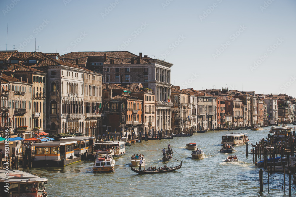 Venice, Italy - July 14th, 2017: Water taxis and gondolas are sailing along the Grand Canal. Grand Canal is one of the major water-traffic corridors in Venice
