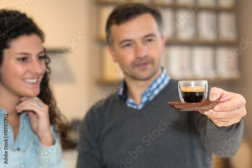 inspecting a cup of coffee