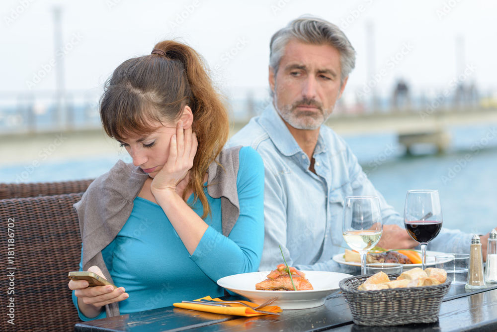 woman disregarding the partner during meal woman disregarding the partner during meal