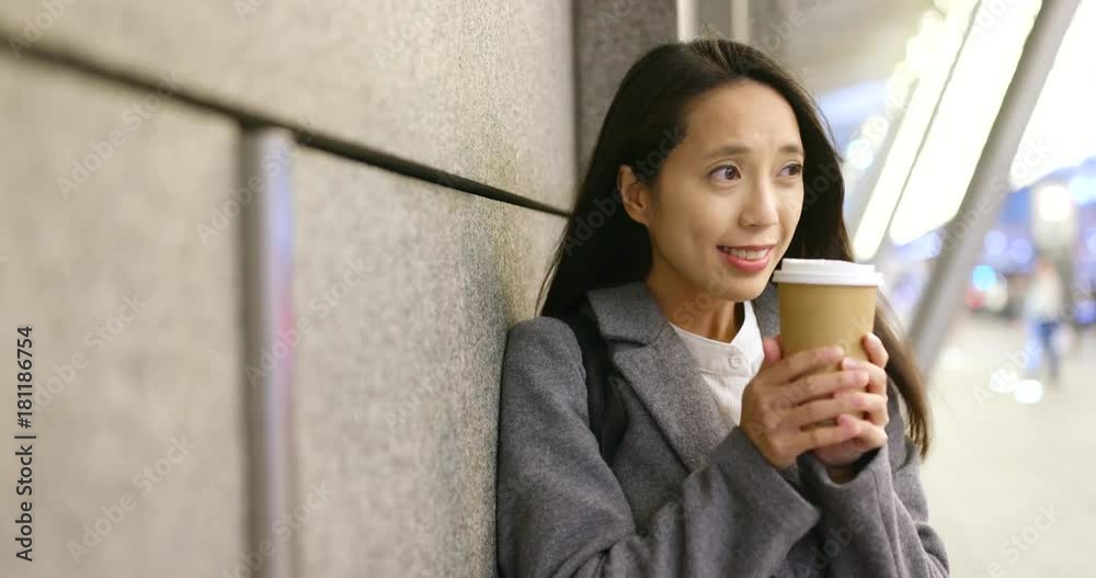 Woman feeling cold outside hold with hot coffee cup in city