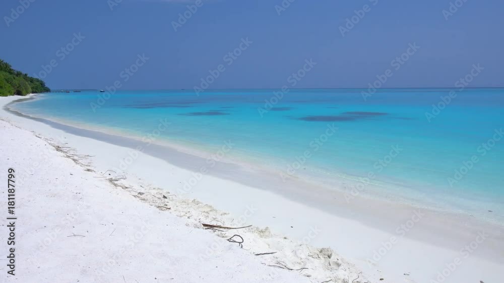 Island at maldivian atoll in Indian Ocean. Wild and uninhabited shore. Getaways destinations Island at maldivian atoll in Indian Ocean. Wild and uninhabited shore. Getaways destinations