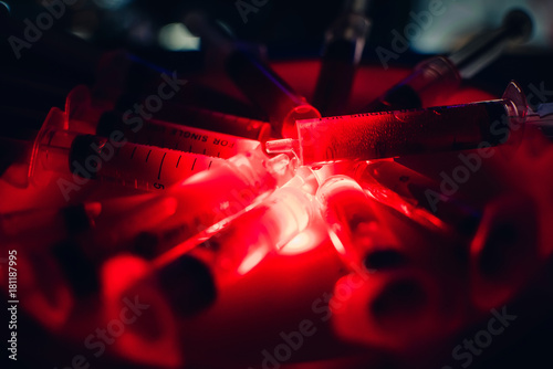 Billede på lærred syringes with blood clearance Halloween horrible on a dark background with red l