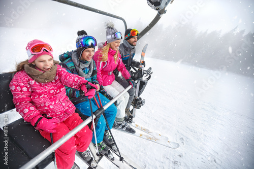 Family in ski lift going to ski terrain