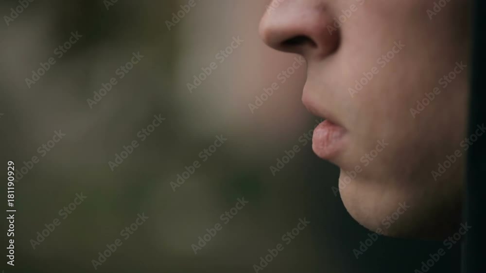 Closeup shot of a man's face who smoking a cigarette. Closeup shot of a man's face who smoking a cigarette.