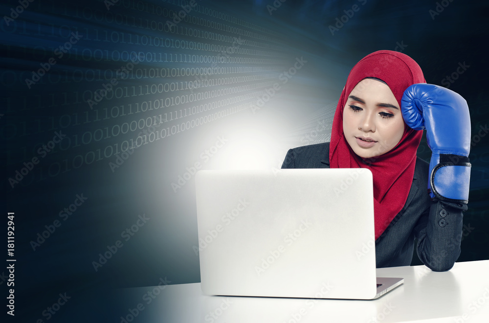 stress young businesswomen with boxing glove look at her laptop.cyber security business concept with abstract double exposure stress young businesswomen with boxing glove look at her laptop.cyber security business concept with abstract double exposure