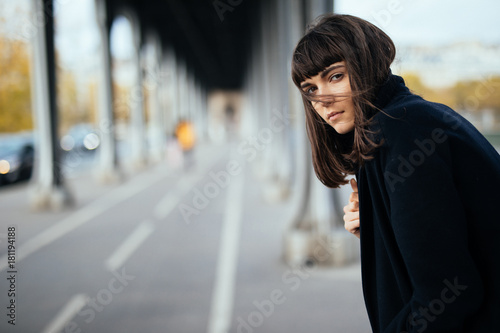 Photography Fashion portrait trendy woman in Paris street at autumn under bridge