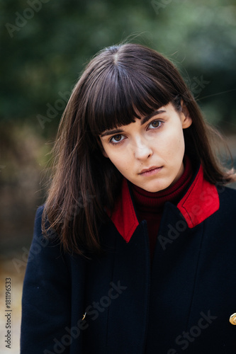 young beautiful brunette woman portrait with short hairs in coat on the Paris streets photo