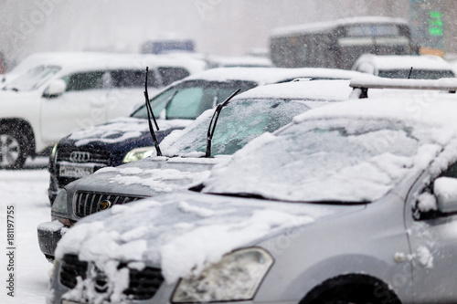 Snow-covered cars with raised wipers. The snowfall in Vladivostok paralyzed the movement in the city