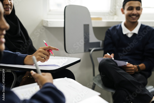 diverse muslim children studying in classroom