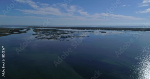 Aerial seascape, in Ria Formosa wetlands natural park, over Cavacos beach. Algarve.