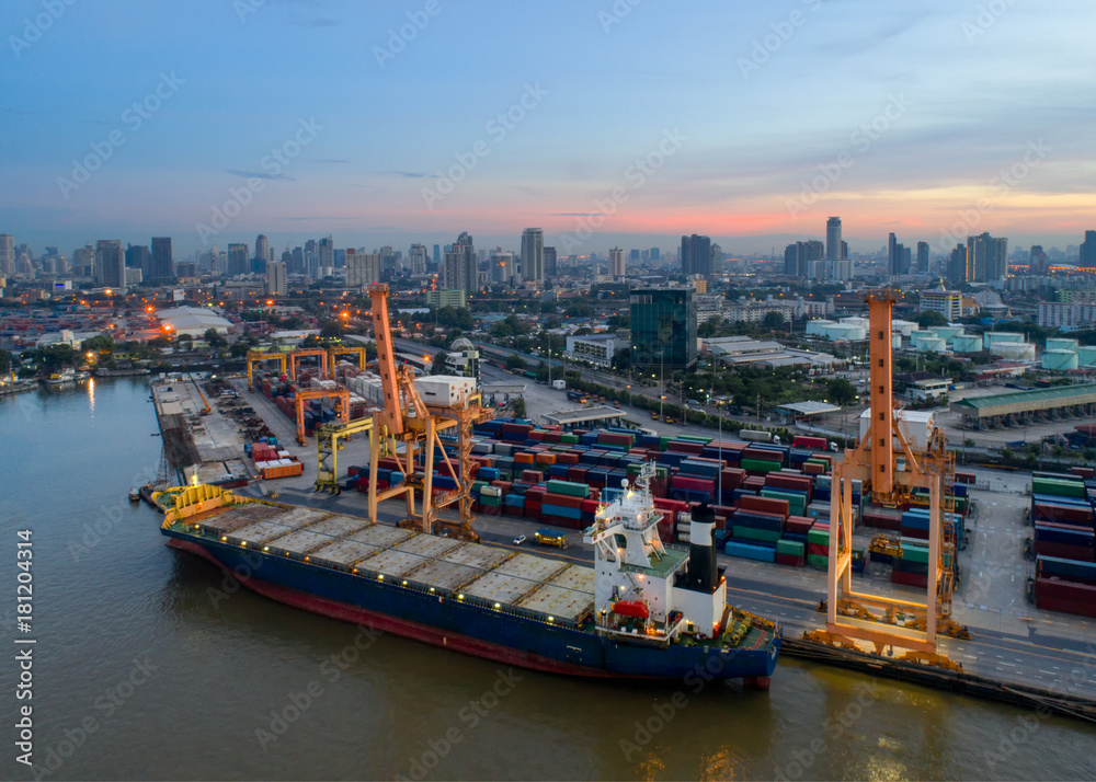 Naklejka premium Containers yard in port congestion with ship vessels are loading and discharging operations of the transhipments in international port.