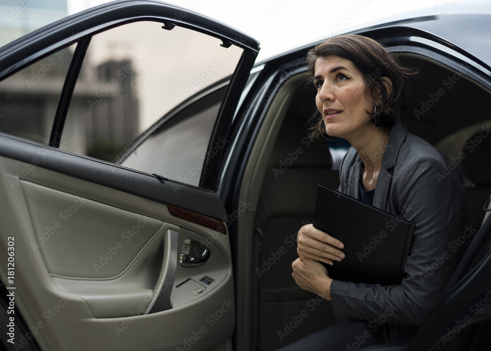 Businesswoman going out of his car Businesswoman going out of his car