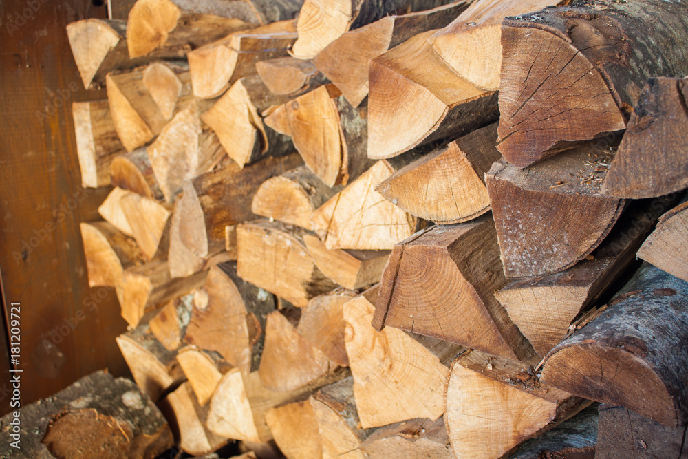 Woodpile of chopped lumber. Pile of wood logs. Stacked firewood timber Woodpile of chopped lumber. Pile of wood logs. Stacked firewood timber