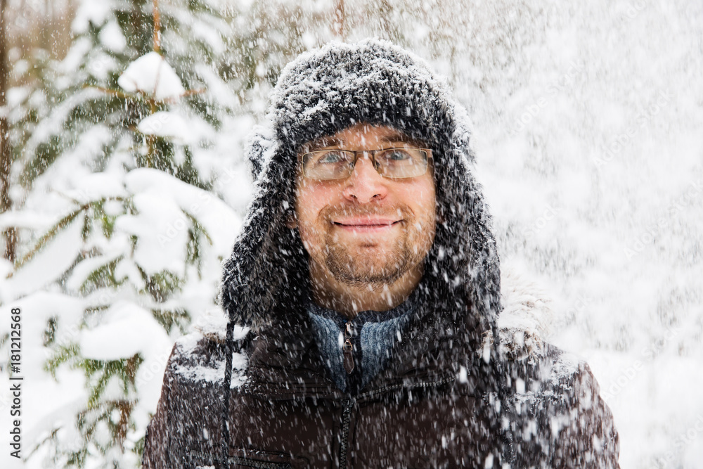 Man in fur winter hat with ear flaps smiling portrait Man in fur winter hat with ear flaps smiling portrait