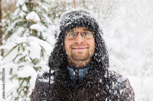 Man in fur winter hat with ear flaps smiling portrait