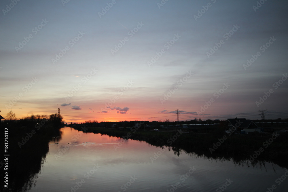 Sunset over the ring canal in Nieuwerkerk aan den IJssel with nice colors and reflection in water