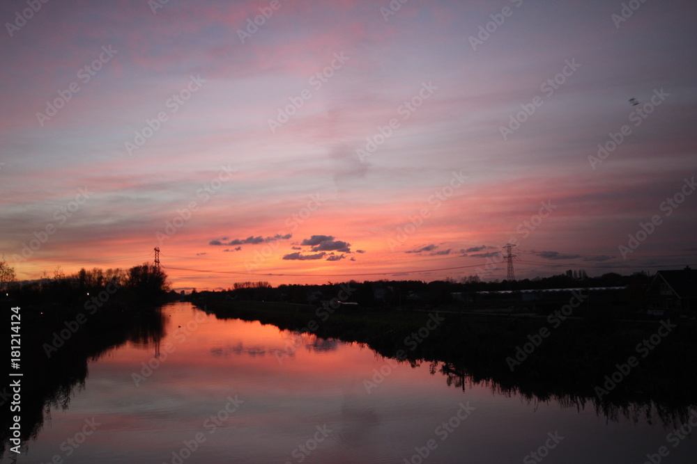 Sunset over the ring canal in Nieuwerkerk aan den IJssel with nice colors and reflection in water