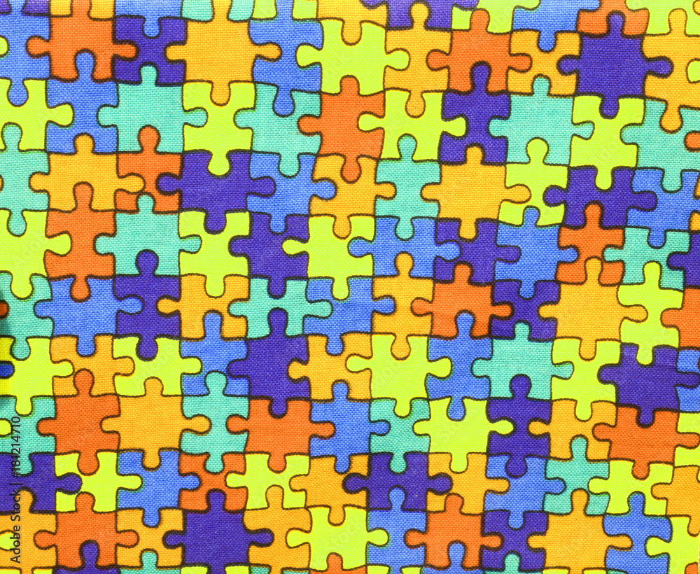 pieces of colored puzzle on cotton fabric pieces of colored puzzle on cotton fabric
