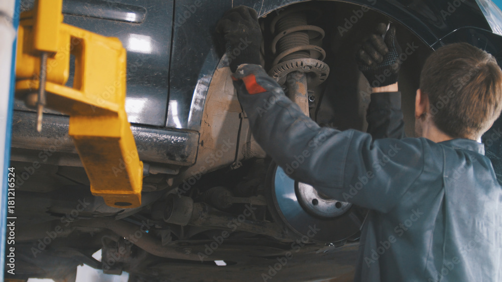 Car in auto service lifting for repairing Car in auto service lifting for repairing