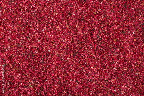 Dried sumac spice as a background, natural seasoning texture photo