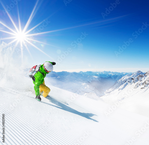 Skier on piste running downhill