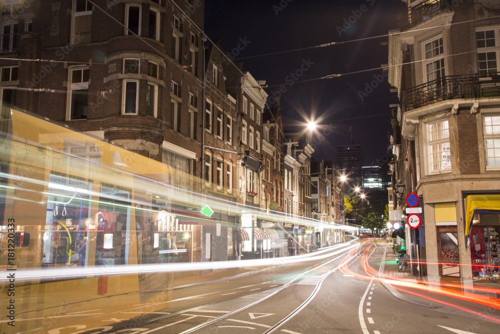 Tram moving fast at night in Amsterdam
