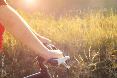 Male cyclist hold handlebar of mountain bicycle