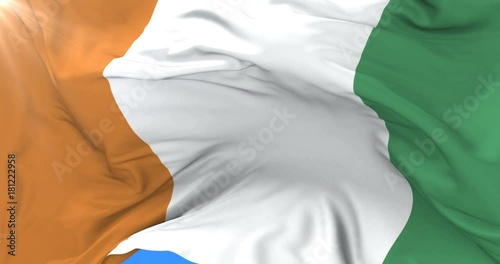 Flag of Ivory Coast or Côte d'Ivoire waving at wind in slow, loop photo