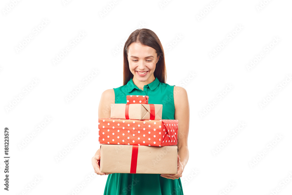 Portrait of young woman posing with heap of gift boxes on white background Portrait of young woman posing with heap of gift boxes on white background