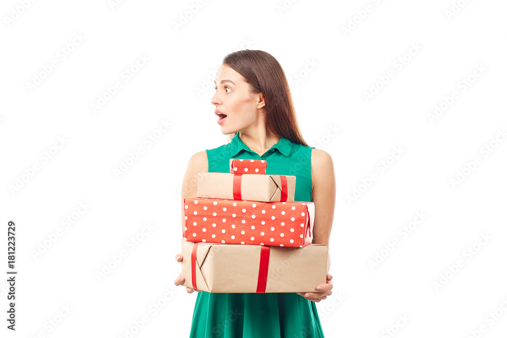 Portrait of young woman posing with heap of gift boxes on white background Portrait of young woman posing with heap of gift boxes on white background