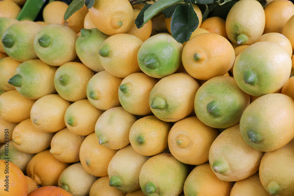 Ripe lemons on a layout in a vegetable store. Ripe lemons on a layout in a vegetable store.