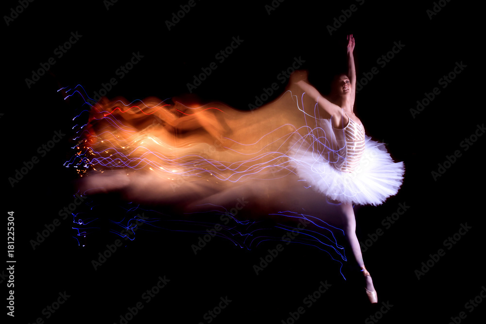 Young female / woman / girl ballerina in white / tutu solo doing jump and leaves