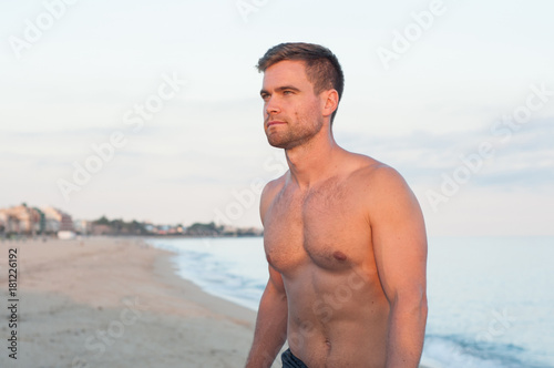 Portrait of topless man at beach