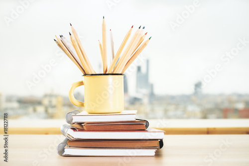 Iron mug with pencils and copybook