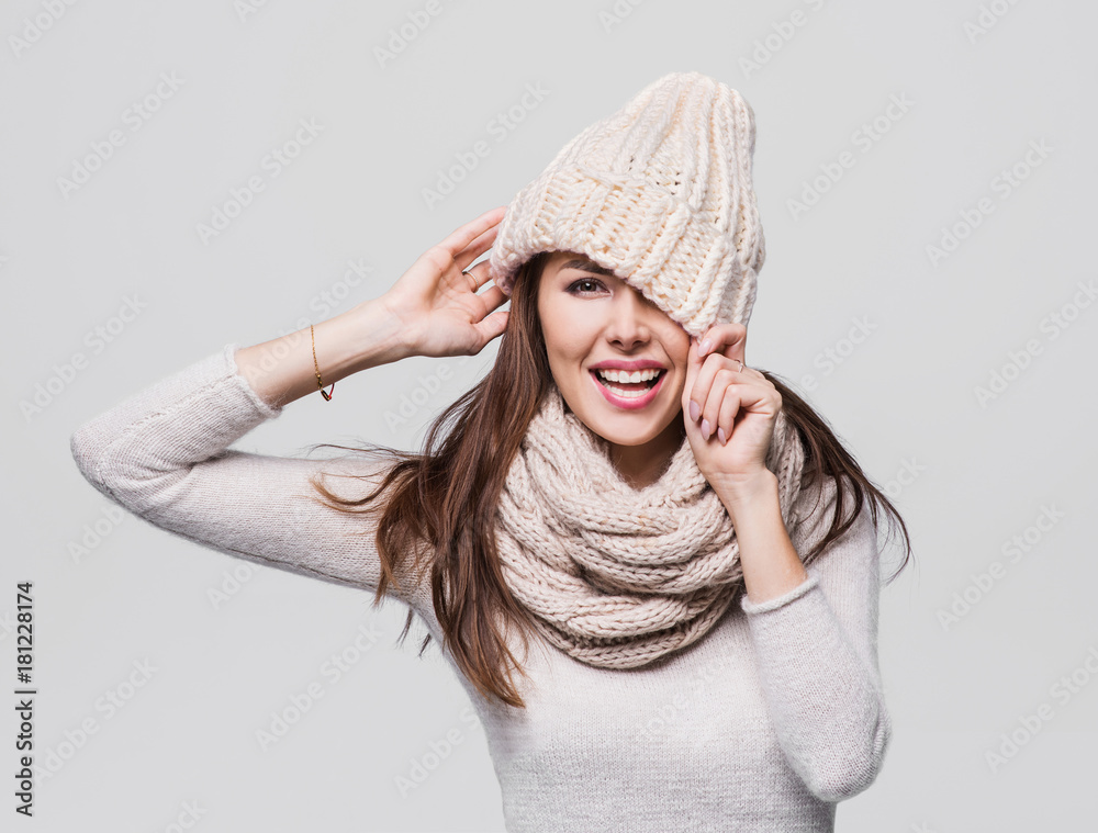 Beautiful woman winter portrait. Laughing girl wearing warm clothes having fun,