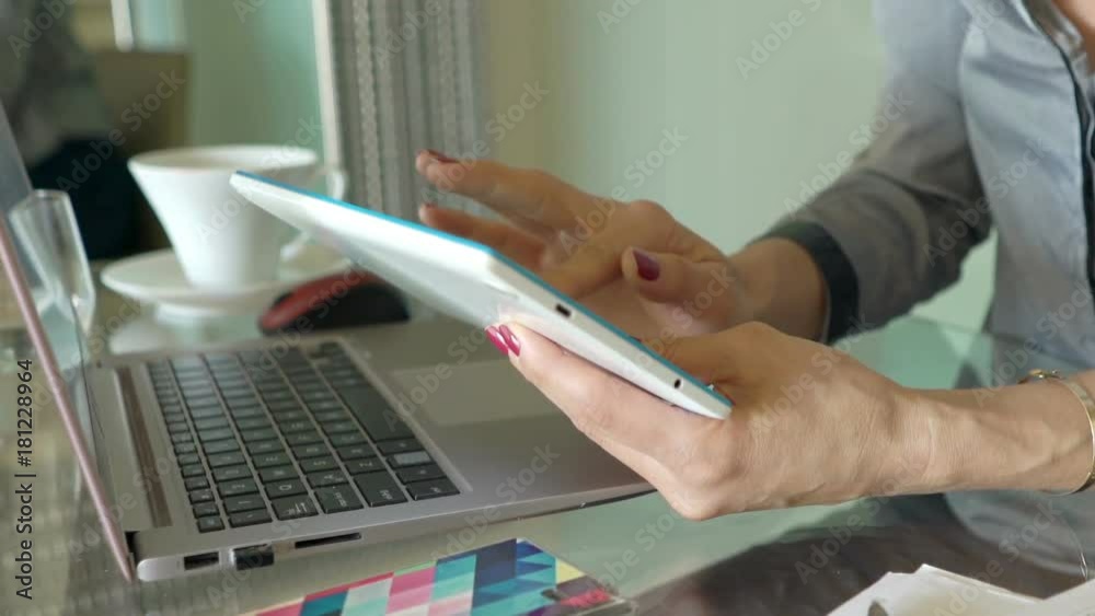 Businesswoman using tablet computer sitting by table in office
Businesswoman using tablet computer sitting by table in office