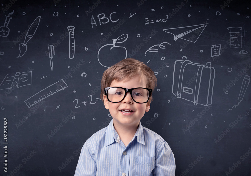 Little boy in front of a drawn up blackboard Little boy in front of a drawn up blackboard