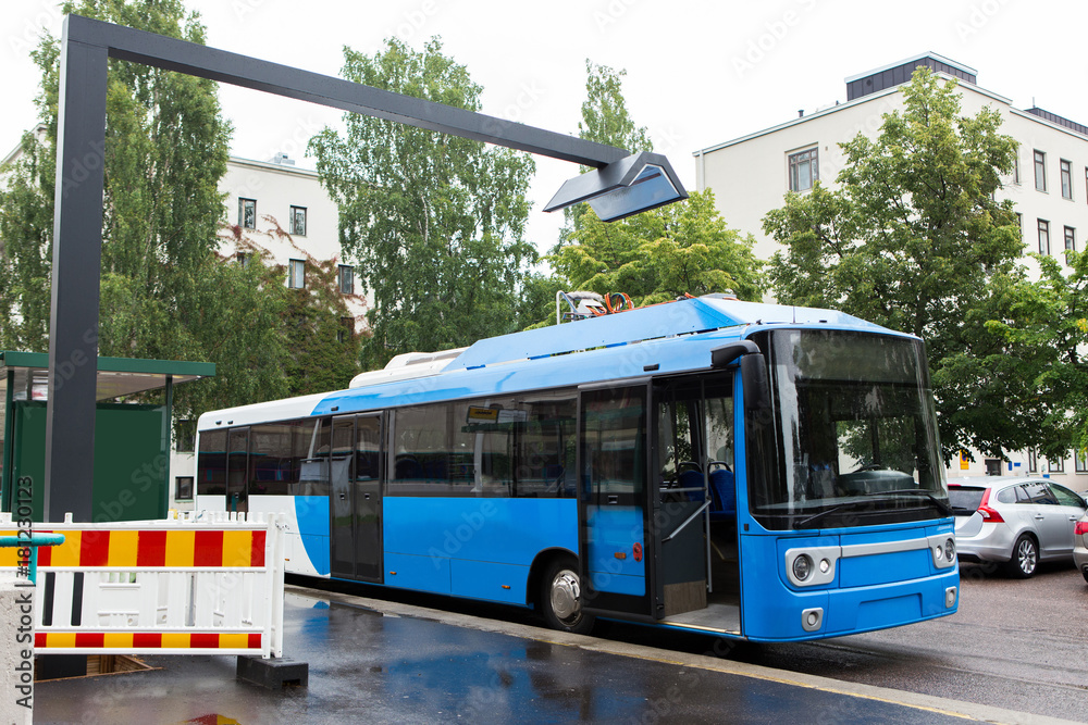 Electric bus is charged by wireless induction charging Stock Photo