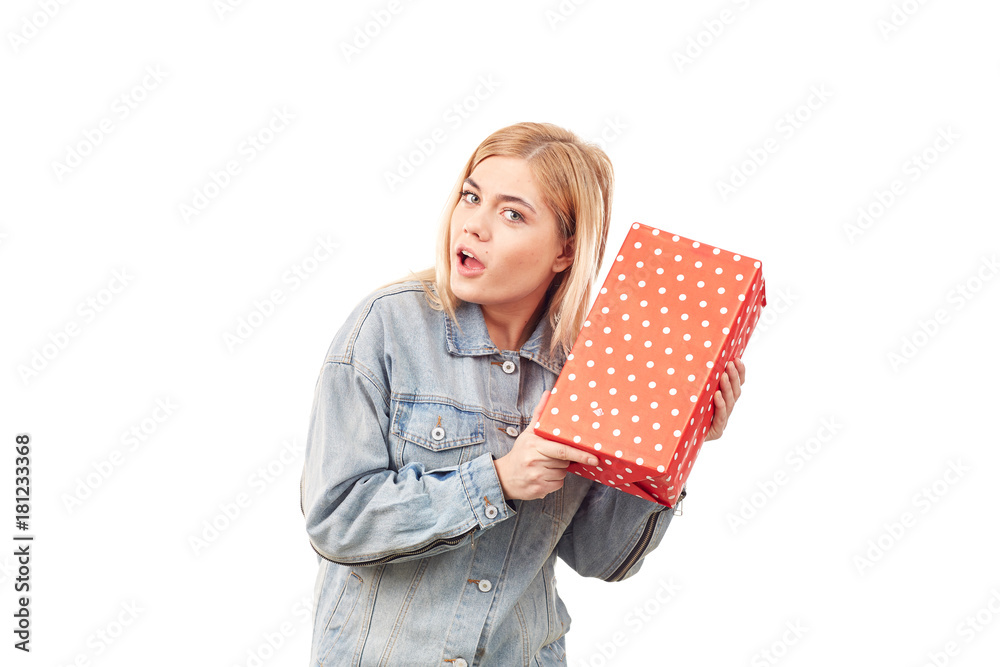 Young blonde in denim jacket holding gift box Young blonde in denim jacket holding gift box