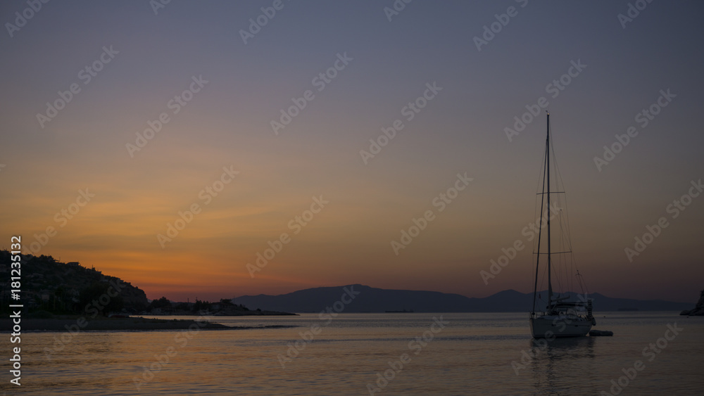 Sunrise with sailboat at sea