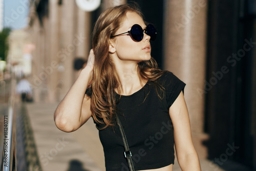 portrait of a girl in glasses on a city background © SHOTPRIME STUDIO