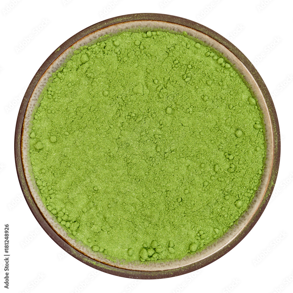 Bio organic wheatgrass powder in ceramic bowl isolated on white background, top view in natural light Bio organic wheatgrass powder in ceramic bowl isolated on white background, top view in natural light