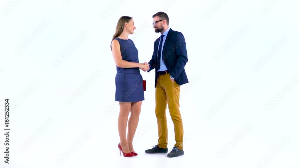 Two business partners shake hands welcoming each other in studio. Slow motion Two business partners shake hands welcoming each other in studio. Slow motion