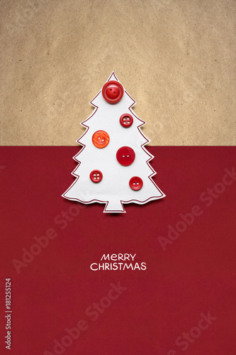 Merry christmas / Creative concept photo of christmas tree made of paper and buttons on red brown background.