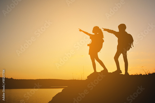 Silhouette women and girl backpacker on the top mountain , Relax time travel on holiday