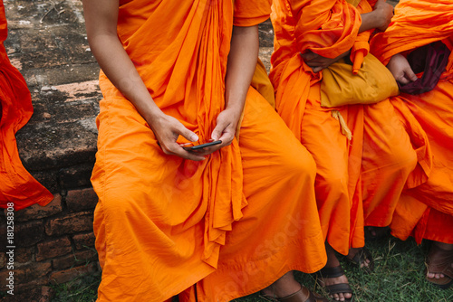 Buddhist monk holding the Smartphone with your hands