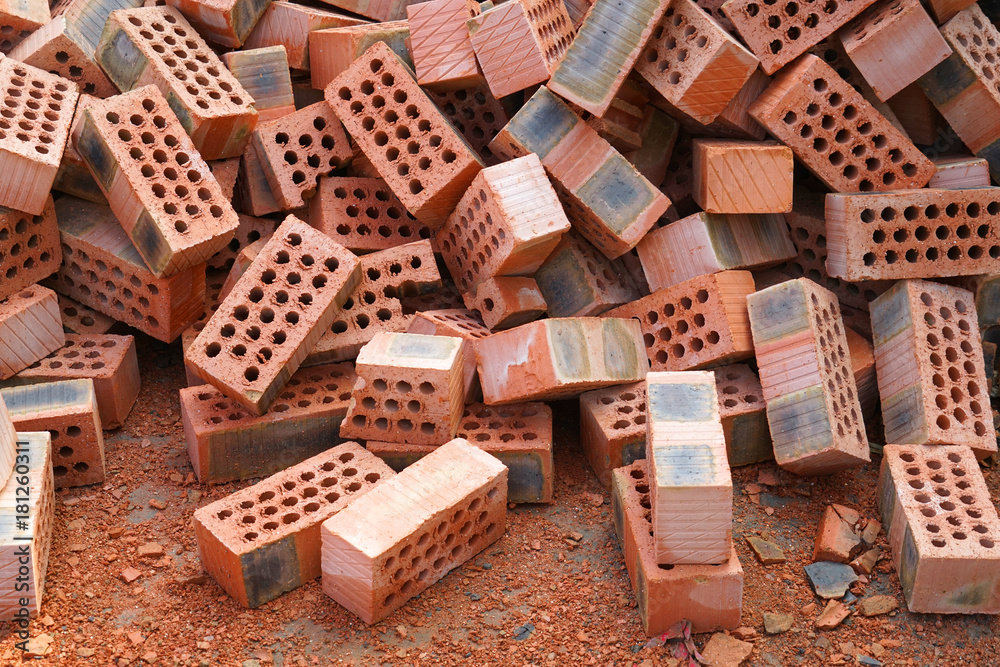 Red clay bricks in piles at construction site